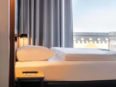 Ein Bett oder Betten in einem Zimmer der Unterkunft B&B HOTEL München-Messe